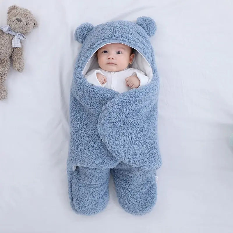 Cute and cuddly blue baby bear blanket with baby wrapped up cozy showing little hands versatile for baby's temperature comfort