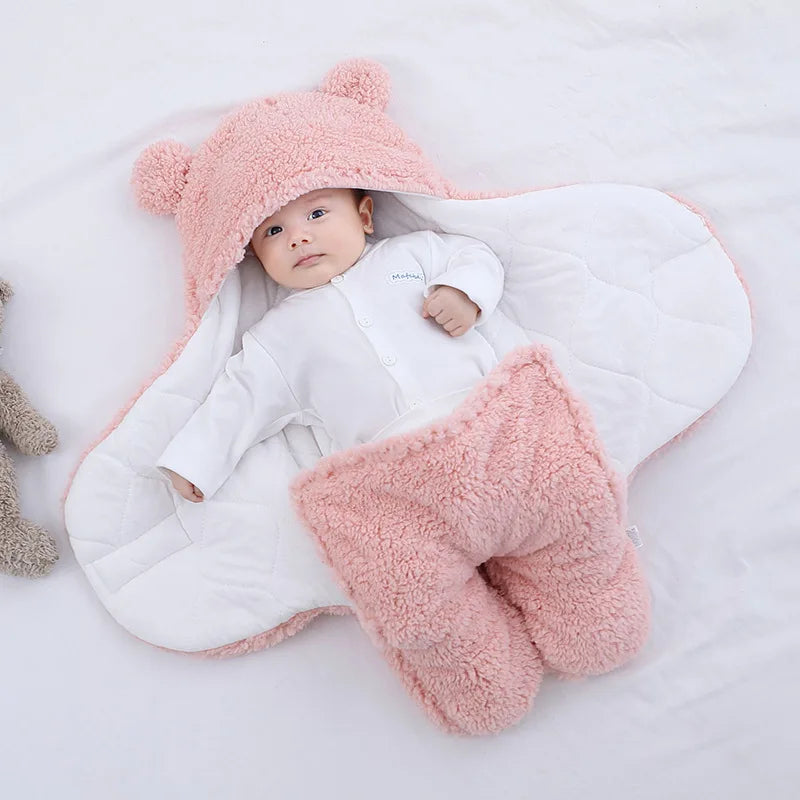 Showing Cute and cuddly pink baby bear blanket with baby wrapped up cozy with arms outstretched versatile for baby's temperature comfort