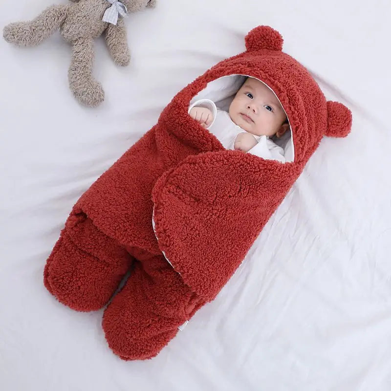 Cute and cuddly red baby bear blanket with baby wrapped up cozy showing little hands versatile for baby's temperature comfort 